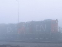 Dense early morning fog makes CN 7106 and 7102 appear almost ghost like as they work the yard in Capreol, Ontario prior to heading to Sudbury with a short train.