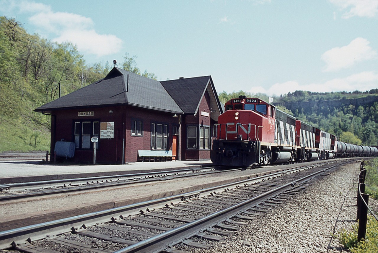 Another nice mid-week day off from work and there is no one around up at Dundas, so I could wander at will, hoping for some traffic to photograph. An example is this westbound passing the old station, CN 9424 and two unrecorded sisters, with general freight behind the initial tank cars. Great memories.