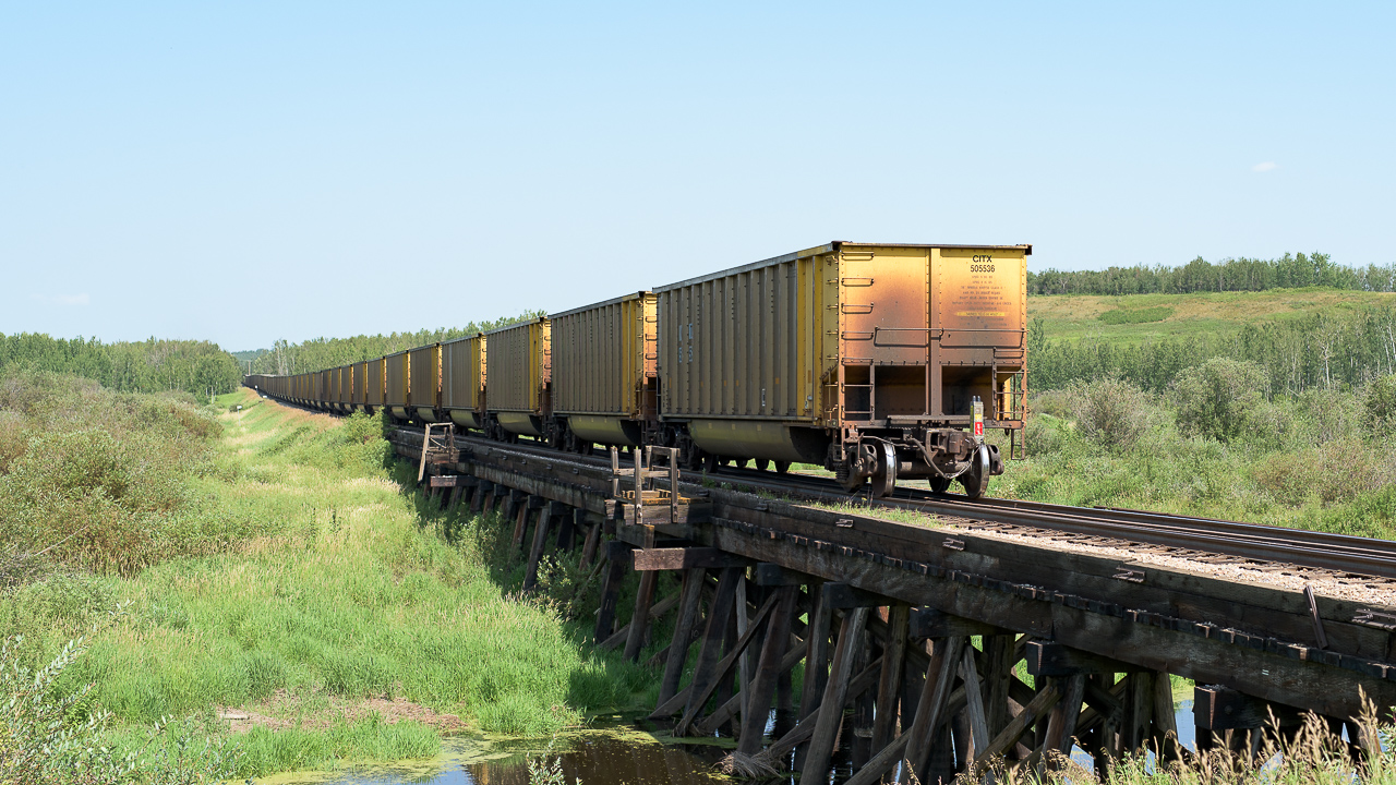 One more set of photos from Redwater, this time located at the Redwater river trestle. The train is the same as in my previous 2018 SD40 photo. Not much has changed in 32 years. Overhead powerlines are gone, trees have grown or been cut, barrels are removed from the trestle. Oh Yeah, and no caboose :-).