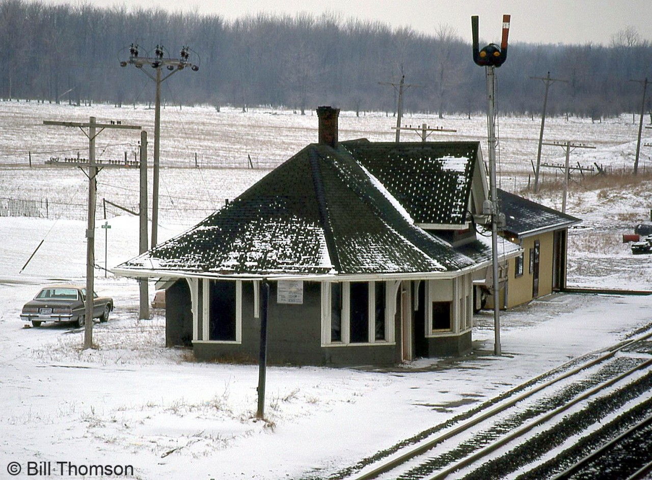 CN's Watford Station is pictured in this snowy January 1983 scene, located at Mile 33.2 of CN's Strathroy Subdivision. This view is looking west off the Main Street bridge to the east.

By 1987 a VIA "kiosk station" had been erected next to the CN station. Both are gone today, although the building pictured next to the station remains, in use by CN maintenance of way crews.