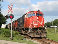 CN 568, with some big power on the point in the form of SD75i 5729, storms westbound out of New Hamburg after completing some switching duties at Nachurs Alpine and Pestell. Note the CN Waterloo St. sign with the distorted noodle. I believe it used to be a G&W or GEXR symbol there.
