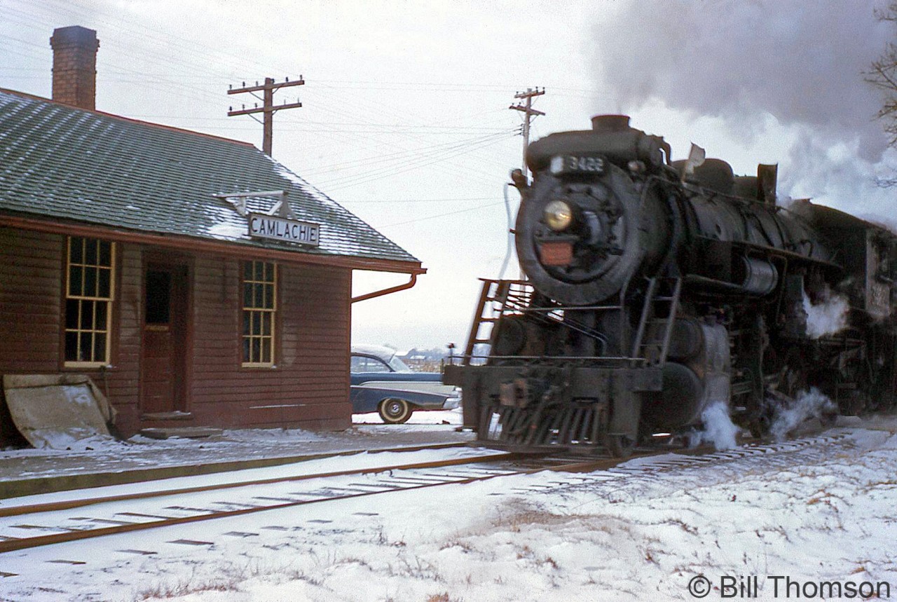 Canadian National Mikado 3422 (an S1f class unit originally built by Alco in 1913 for the GTR) handles the Sarnia-Stratford wayfreight as it steams past CN's Camlachie station on a snowy day in 1959.  Camlachie was located at Mile 56.69 of CN's Forest Subdivision, which originally opened in the 1850's as part of the Grand Trunk's Sarnia-Toronto mainline. As the CN Forest Sub, the line ran between St. Mary's Junction to Sarnia Junction and served as a branchline until it was abandoned in portions during the 1980's.  A CN RSC13 in front of Forest Station: http://www.railpictures.ca/?attachment_id=18320.
