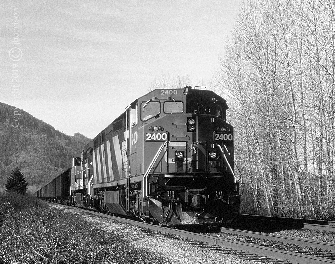 CN 2400, a GE Dash 8-40CM, with the 2521 trailing are in the siding at Arnold to let a westbound pass before continuing eastward and eventually up and through the Fraser & Thompson canyons.