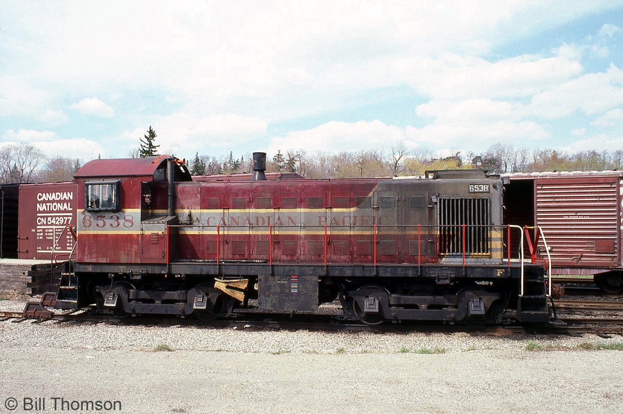 CP S3 6538 is shown parked in Guelph near the old stone freight building in April 1981. By this point in time, CP was phasing out its old Alco/MLW switchers (many dating back to the steam era), and the final ones would be retired in the mid-80's. CP 6538 was retired in 1985, and one of the last units on the roster still in the maroon and grey "block" livery (having never been repainted in action red paint).A few notable features about this unit are the handrails touched up with modern action red and black paint, the watchman's heater (for keeping the engine warm when shut down at branchline outposts), front numberboard, 3-chime horn, exhaust spark arrestor and air vents cut into the front cab roof.