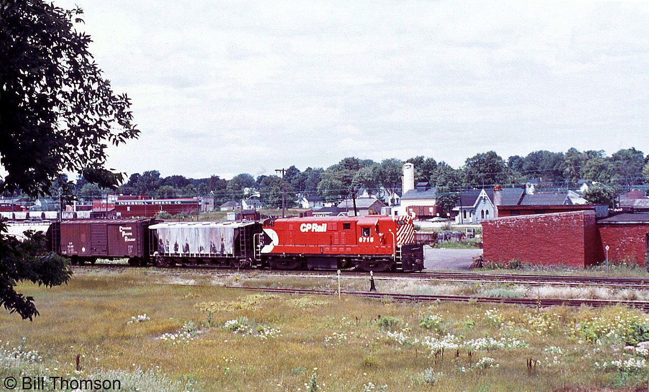 CP H16-44 8715 is seen switching at Ingersoll in July 1972. The view here is looking northwest from the CPR Ingersoll yard area at Mile 8.9 of CP's St. Thomas Sub. CN's Ingersoll station is visible in the background on the right, along their Dundas Sub on the other side of the Thames River. On the left in the background one can see the Ingersoll Cheese Company building by some CN hoppers (CP's St. Marys Sub had a spur running along Carnegie St. to access their siding).  Nelson BC was traditionally the home of CP's fleet of FM/CLC power which rarely made it to the east, but units 8715 and 8716 were outfitted for use on the Speno rail grinding train that roamed the system including in the southern Ontario area. Both weren't always used at the same time, and sometimes one would make it into regular freight or local service.