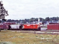 CP H16-44 8715 is seen switching at Ingersoll in July 1972. The view here is looking northwest from the CPR Ingersoll yard area at Mile 8.9 of CP's St. Thomas Sub. CN's Ingersoll station is visible in the background on the right, along their Dundas Sub on the other side of the Thames River. On the left in the background one can see the Ingersoll Cheese Company building by some CN hoppers (CP's St. Marys Sub had a spur running along Carnegie St. to access their siding). <br><br> Nelson BC was traditionally the home of CP's fleet of FM/CLC power which rarely made it to the east, but units 8715 and <a href="http://www.railpictures.ca/?attachment_id=23620"><b>8716</b></a> were outfitted for use on the Speno rail grinding train that roamed the system including in the southern Ontario area. Both weren't always used at the same time, and sometimes one would make it into regular freight or local service.