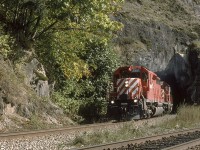 CPXW 5615 and 5821, two GMD SD40-2's, emerge from the west portal at SNS Magellan on the CP Cascade Sub just west of Agassiz B.C. There are two tunnels located here, side by side. One for westbound traffic, one for eastbound, and long before directional running between Kamloops and Vancouver. The local fishermen walked westward through the eastbound tunnel to get to their favorite fishing holes. I can't remember how railfans of the day managed it. I think we went up and over. 

In the early 90's it was possible to pick up the daily east and westbound lineups on our scanners at around 0700 every morning. Barring any delays it worked out well and made it possible to pre-plan several good locations for the day, which were and still are, quite spread out between Chilliwack, Boston Bar - North Bend, and beyond.

Courtesy the Trackside Guide, and please correct me if I'm wrong: The 5615, built in 1972, was sold to Larry's Truck Electric in 2016. The 5821, built in 1974, was sold to Helm Financial in 2006 or 7. 

I used a Pentax SP 1000 before upgrading to a Canon Eos Elan, and Kodachrome 64 or 200 for all trackside photos taken between '94 and '97.         