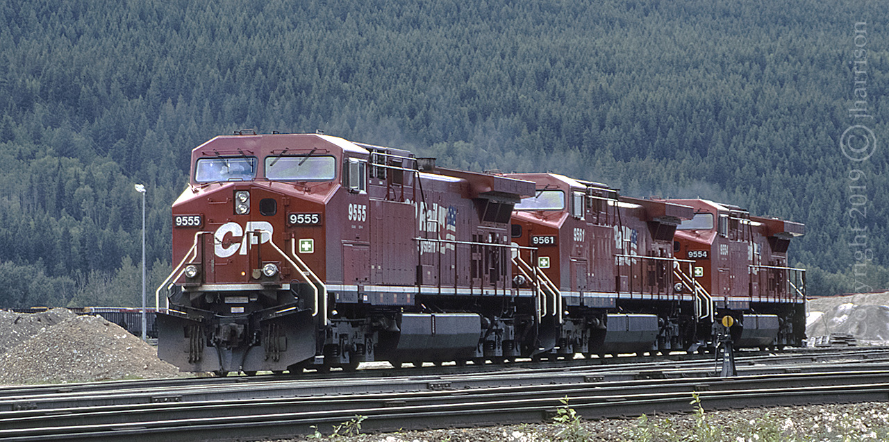 Three GE AC4400CW's, built in 1995, and seen here at CP's Golden B.C. Yard in June, 1997. A great yard to photograph from the perimeter. 

The 9555 was rebuilt in 2018 as AC4400CWM #8016, as was the 9561 which became #8051. The 9554 was delivered for rebuild in Texas in February 2019 ..... to the best of my knowledge.
