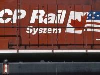 The dual flag logo on CP 9575 at Golden Yard - CP Windermere Sub in June of '97. The trailing unit was CP 9502, and much farther back - RCU 9548. 