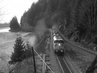 An eastbound CP power transfer about to enter the east track portal at Harrison Mills on CP's Cascade Sub. The lead unit is the 9006 with trailing units 5974 / 5962 / 5997 / SOO 6025 / CP 6071 / 5761 and 5525. From what I can gather, only the SOO 6025 remains in service. It was renumbered to CP 6225 in 2011. Station name signs have changed over the years. In 1995 this location was known as Harrison Mills. No relation. 