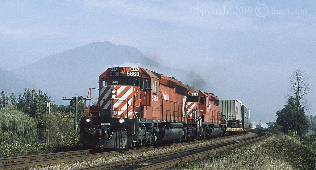 CP 5668 with the 5913 and RCU's 5708/6046 trailing, was westbound at MP 82.36, and at what used to be listed as Suicide Creek on CP's Cascade Sub. GPS is approximate with the closest villages east and west of this location being Lake Errock and Deroche.