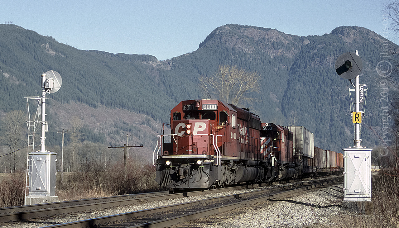 CP 6000 with the 5663, laden with one semi-trailer and a single layer of containers, are headed west at MP 63.2, SNS Magellan, on the CP Cascade sub just west of Agassiz B.C. Both units are SD40-2'S. The 6000 (Blt.1980) was rebuilt in 2017 as SD40-3 #5100. The 5663 (Blt. 1973) was declared surplus in late 2006 and sold to Larry's Truck and Electric in late 2008. It became LTEX #5663.
 

Information in part courtesy of: CPRDIESELROSTER.COM and The CDN Trackside Guide.