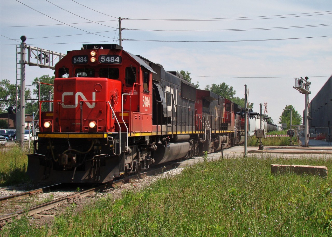 Here we see CN detour train 326 lead by 5484, 2541 and 8933 heading up the Chrysler Spur minutes before he hits the Chatham Sub. for London. This once lightly used branch line experienced quite the increase in traffic over the two weeks that the tunnel in Sarnia was closed. On top of the 2-4 trains per day, another 4-6 were added, testing the jointed rail at the curves. It was a fun experience chasing these trains as they offered a variety of power and freight that rarely if ever comes to Windsor anymore (seeing frame cars here again was choice), and I got to meet some new railfans/ hangout with old ones. Some good times indeed.