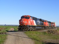 CN train #120 rounds the curve at Aulac, NB as they are about 2 miles away from the border with Nova Scotia with a shiny ES44AC leading the charge