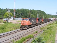 CN train #407 rolls by the site to where the former station once stood with an SD75I & a C44-9W for power