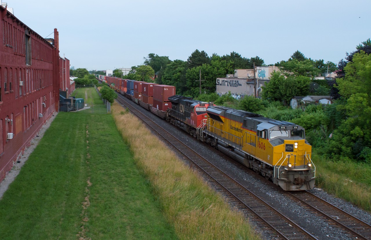 CN Q124 (detouring CN 148) passes through the heart of downtown Hamilton with EMDX 1606 leading the way.  This is a rare catch for two parts, the EMD Demonstrator leading and an intermodal on the Grimsby Subdivision.  CN spent a little over a week detouring train via CSX and NS in Buffalo as well as through Windsor on CP/Via and Northern Routes.