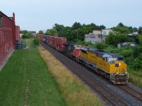 CN Q124 (detouring CN 148) passes through the heart of downtown Hamilton with EMDX 1606 leading the way.  This is a rare catch for two parts, the EMD Demonstrator leading and an intermodal on the Grimsby Subdivision.  CN spent a little over a week detouring train via CSX and NS in Buffalo as well as through Windsor on CP/Via and Northern Routes.