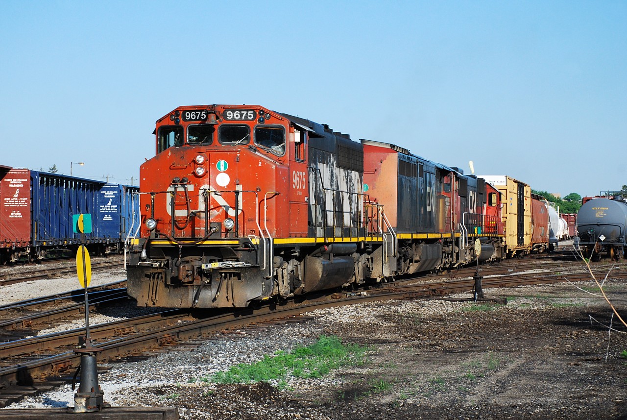 The summer months allow for some nice early morning photography from the north side of the yard in Brantford.  June 26 was a clear, bright morning and I had a few minutes to spare before heading to work so I swung by the yard and was rewarded with 580 already at work with CN 9675, CN 2444 and CN 5470.  Over a month later (July 30) and this consist is still together on 580.  Today they were busy with a short ballast train assisting with derailment repairs following the little mishap in Paris last night.