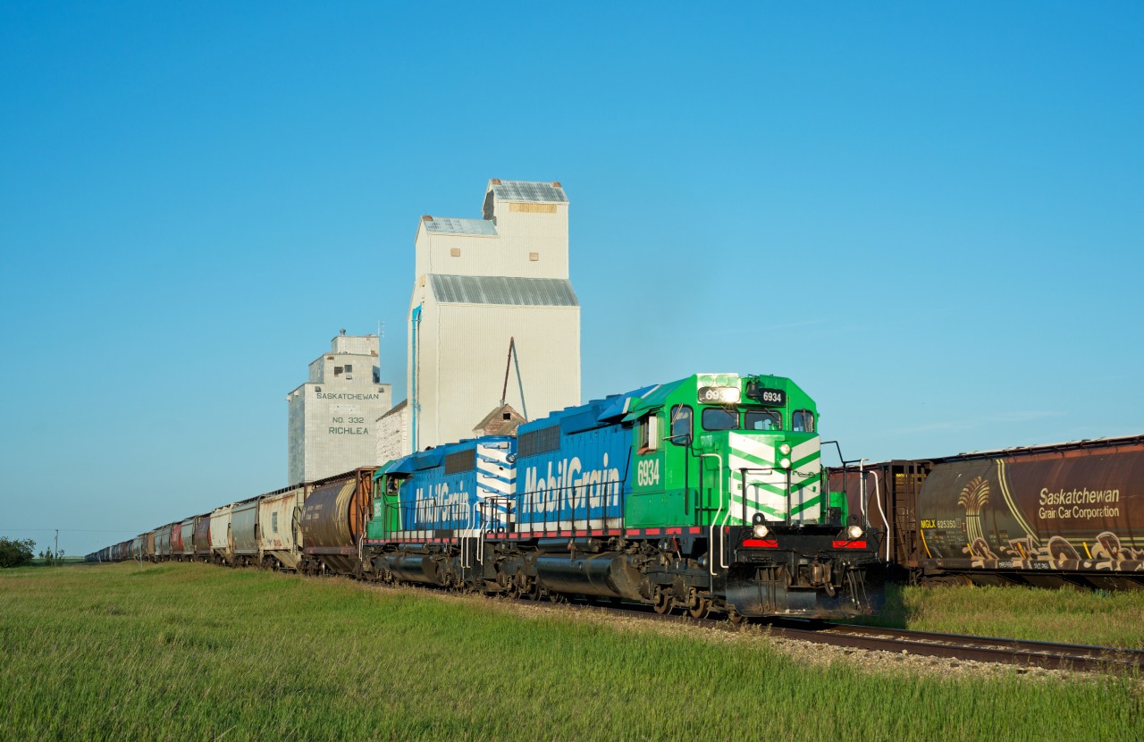 Big Sky Rail 6934 and 6935 lead a hefty train through Richlea Saskatchewan.