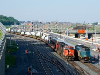 VIA 6418 brings up the rear of VIA 28 as it passes windmill train CN X311, which is stopped as the inbound crew awaits the outbound crew.