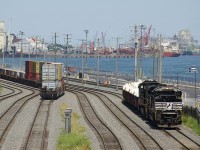 A CN transfer with NS 1094 and NS 9121 for power is lifting some gondolas before departing the Port of Montreal for Taschereau Yard.