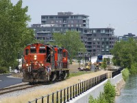 CN 7229 and CN 4115 are heading west on the East Side Canal Bank Spur after dropping off a single grain car at the Ardent mill. 