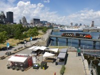 The Pointe St-Charles Switcher is heading light power to pickp up cars in the Port of Montreal with CN 4129 & CN 4700 for power. In the background the cruise ship <i>Victory II</i> is docked.