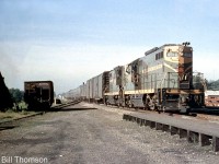 Grand Trunk Western passenger service "Torpedo Tube" GP9 4910 leads a sister unit eastbound through Port Credit in 1958, on train #14 the morning "International Limited" from Chicago for Montreal via Toronto. Note the boxcars on the head end, one being an "automobile boxcar" equipped with end doors for easier automotive loading. <br><br> Unlike Canadian parent CN that preferred using steam generator cars when using GP and RS hood units on passenger trains, the GTW purchased a handful of GP9's specially equipped with steam generators, water tanks and rooftop-mounted air tanks for passenger service, and numbered them in their 4900-series. <br><br><i>More at Port Credit:</i><br>RDC's at Port Credit Station: <a href=http://www.railpictures.ca/?attachment_id=21410><b>http://www.railpictures.ca/?attachment_id=21410</b></a><br>CNR 6070 at Port Credit Station: <a href=http://www.railpictures.ca/?attachment_id=24345><b>http://www.railpictures.ca/?attachment_id=24345</b></a><br>Doubleheading Northerns crossing the Credit River: <a href=http://www.railpictures.ca/?attachment_id=24345><b>http://www.railpictures.ca/?attachment_id=24345</b></a>