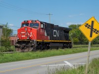 CN 2528, operating as CN L562, begins the light power journey back to Port Robinson after dropping a lone tank of chlorine at Vale in Port Colborne. They are pictured here on the Macy Spur (I believe this is the Macy that parallels Durham Street outside of Vale) on the west side of the crossing that goes into Vale. I had posted <a href="http://www.railpictures.ca/?attachment_id=37474">a shot</a> of a 563 on the east side of the crossing at night back in May. <br><br>I posted  <a href="http://www.railpictures.ca/?attachment_id=37831">this shot</a> of this particular 562 earlier, where they can be seen running down the Humberstone Spur long hood forward with the chlorine in tow. This is a fun, and easy chase. Just a matter of being in the right place at the right time. 
