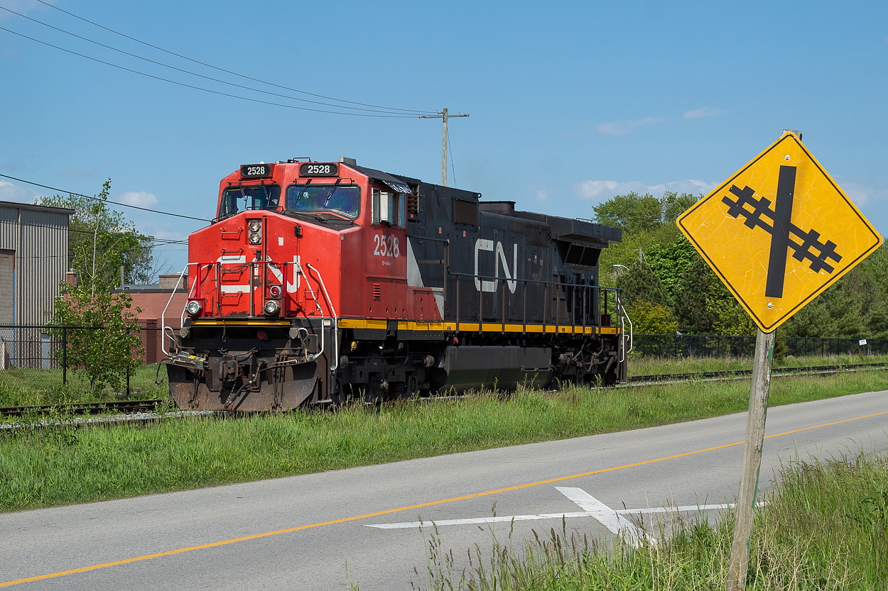 CN 2528, operating as CN L562, begins the light power journey back to Port Robinson after dropping a lone tank of chlorine at Vale in Port Colborne. They are pictured here on the Macy Spur (I believe this is the Macy that parallels Durham Street outside of Vale) on the west side of the crossing that goes into Vale. I had posted a shot of a 563 on the east side of the crossing at night back in May. I posted  this shot of this particular 562 earlier, where they can be seen running down the Humberstone Spur long hood forward with the chlorine in tow. This is a fun, and easy chase. Just a matter of being in the right place at the right time.