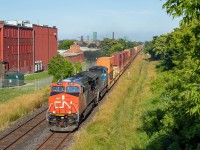 This was a nice treat to see a stack train on the Grimsby Sub. Pictured here at about mile 42.5 or so, detour train 122 is on the hot track, continuing its journey towards BIT. <br><br>This was my second time doing this angle (the first was for <a href="http://www.railpictures.ca/?attachment_id=37397">a late 331</a> when I decided to finally try it out), and I chose this spot as it is unmistakably Hamilton, and shows much of the CN stacks going through town. Clouds were looming large behind me as I watched 122 approach, and another three minutes or so and I would have lost all sun. These were tense moments indeed.