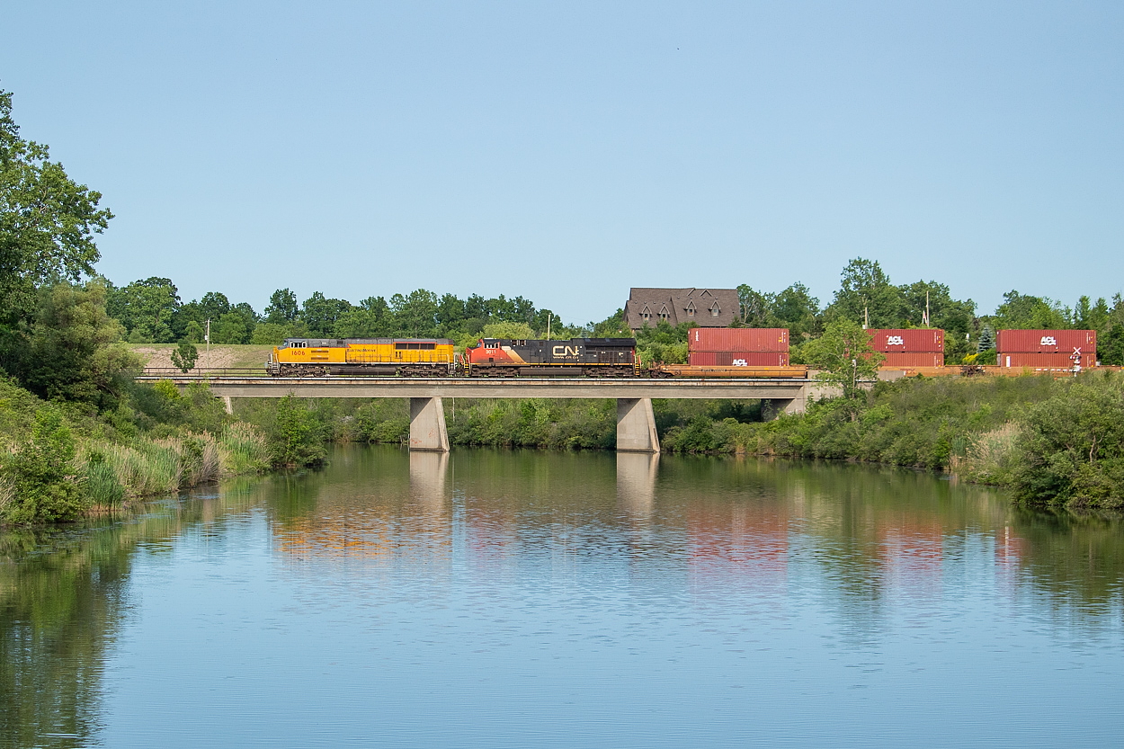 Have you ever got a shot you were personally quite pleased with only to come across a train about a month later much more deserving of the angle? Well, that's what happened to me today. About a month ago I shot the CN spray train crossing the Welland River on its way to Port Rob and thought to myself "well that's pretty neat." Tonight however, detour train 122 with EMDX 1606 on point came into Canada in the early evening hours from Buffalo, and as far as I am concerned is much more deserving of this location. Talk about the pinnacle of the hobby - a detour train (for those not local, CN never runs stacks on the Stamford) with an EMDX demonstrator leader in the soft evening sun. Worth the drive indeed, and I hope you all don't mind the repeated angle.