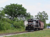 1001 heads back to Utopia with one car after crossing Anne Street in Barrie. After a couple more rail lengths it will be rolling on 80 lb rail.