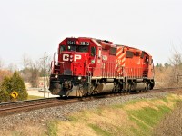 Canadian Pacific train T69 heads westbound through Innerkip, Ontario with only light power on a spring morning. The consist includes; SD40-2's 5943 and 5999.