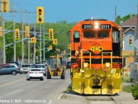 A gaggle of transportation methods roll down Clarence St in Brantford as RLHH 2111, which only made an appearance here for a few weeks before the line switched from SOR to Trackmobiles. I'm still holding out for a photographer who might have photos of CN down here before 2001 (when the Burford was scaled back 10 miles).
<br><br>P.S: Note the broom by the Conductor's window.