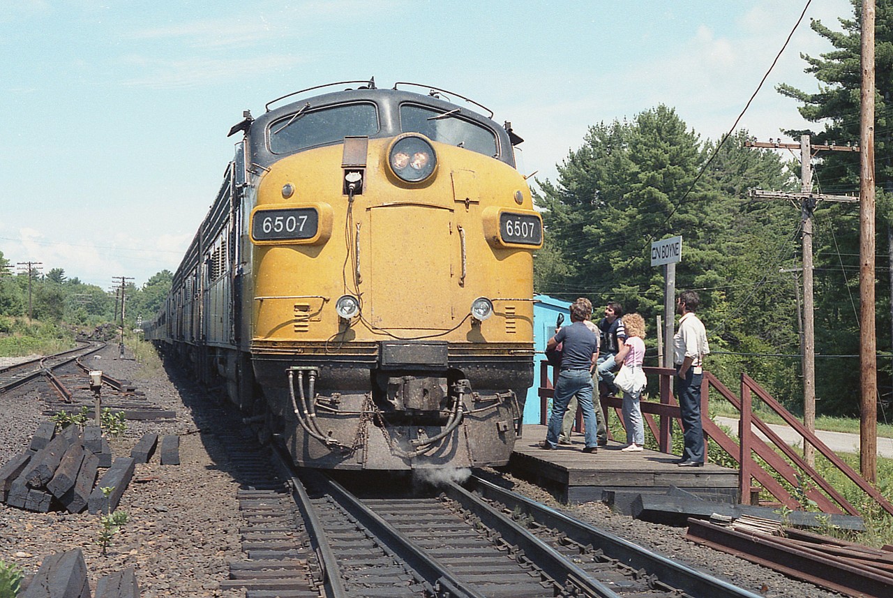 VIA's Southbound Toronto connection has stopped at South Parry's "CN Boyne" for a crew change and it looks like all hands on deck. The location is 3 miles S of Parry Sound off James Bay Jcr Rd north. This is still an interesting photo location as transcon lines run side by side, with CP on the left.(CP Reynolds) Interesting to note the 'remains' of a crossover here. In this location I can remember at least 3, maybe 4 times operations have called for crossover changes at this point. This one was pulled and the opposite installed. More than once. Currently, what you see in tatters has been replaced, as this is where CN northbounds (read: west) cross to the CP track as they run north over the CN/CP Directional Running Zone.(DRZ) Or "shared asset zone" if you prefer.  Trains go back on their own lines at St. Cloud, just south of Sudbury. All regular trains North on CP, South on CN.
Power on todays train is VIA 6507, 6618 and 6627. Note that 'ditch-light' system appears to be in its infancy stage. :o)
