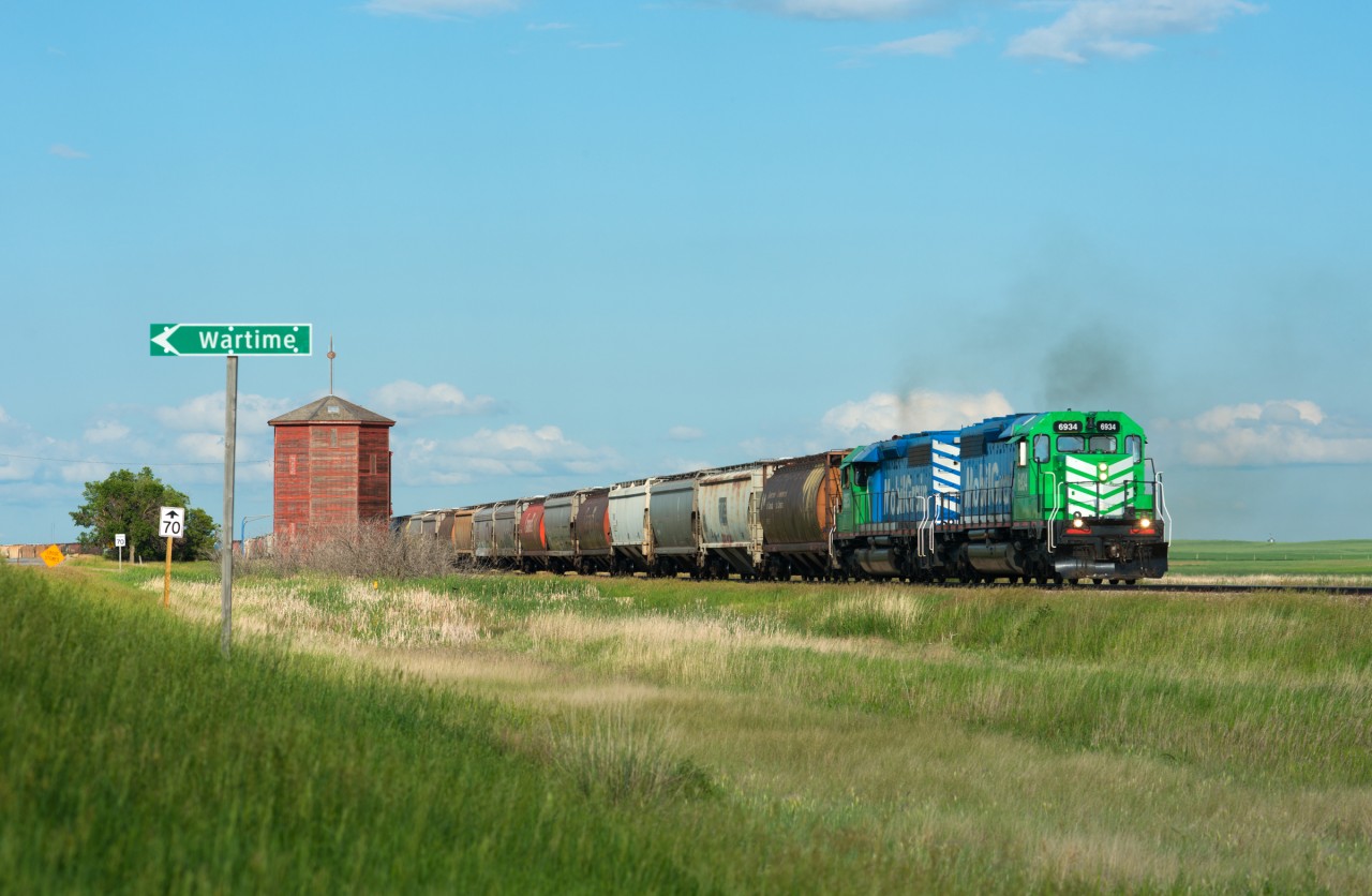 A Big Sky Rail westbound passes the old water tower at Wartime SK, eventually bound for Glidden SK.