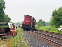 A CN team is on hand to get MLW M636 CN 2308 back on the rails so that CN Dundas sub can be repaired and re-opened.<br>
CN Dorchester was a location east of London ON that had a hand-throw switch siding; it last appeared in the Dundas Sub timetable of 1995. CN 2308 was among the M636's retired in 1995. <br><br>
Another image of this incident shows 2 leaning box cars and 2 leaning covered hoppers at the short hood end of CN 2308 - giving the impression that CN 2308 was the trailing unit.<br>
Date and Location mapped are approximate.