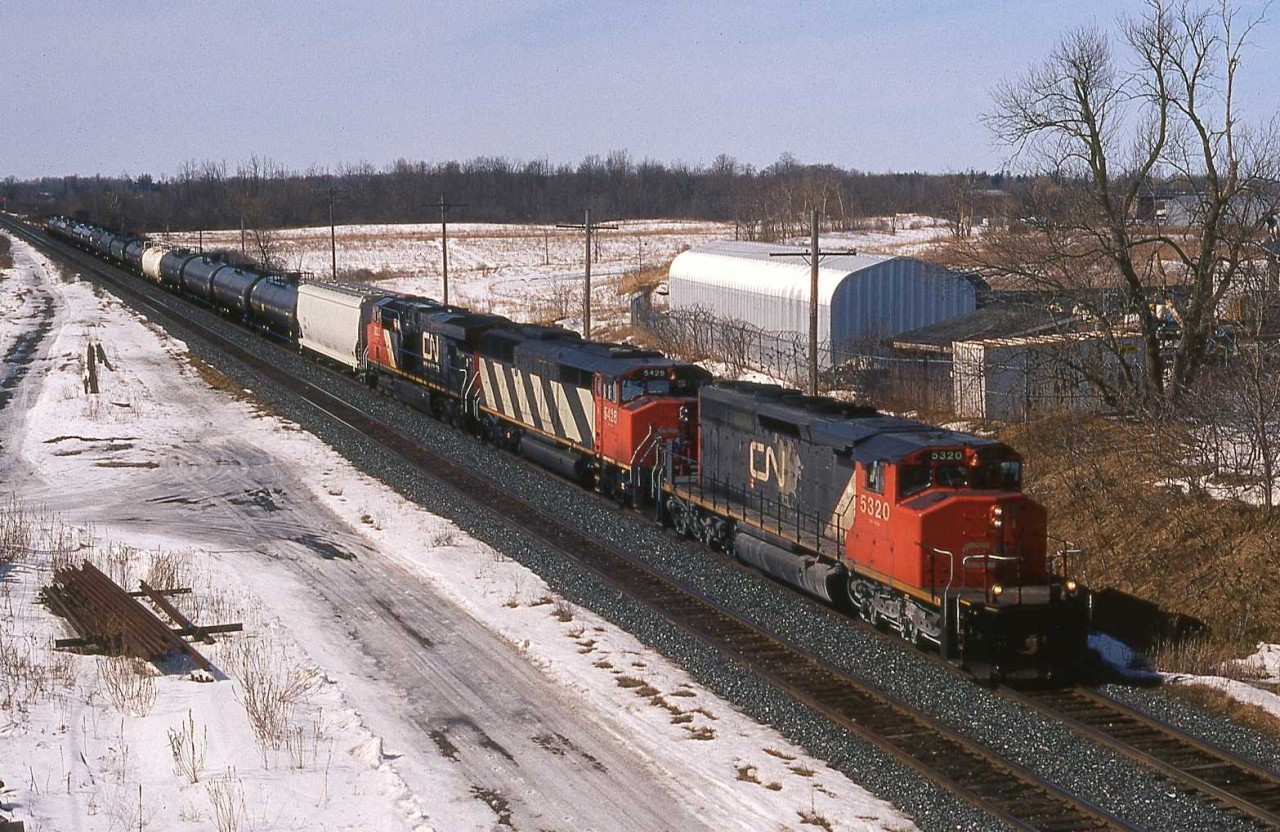 Plenty of power - some 10,600 HP! CN SD40-2 (W) 5320 (GMD 12/1979) together with SD50F No. 5428 (GMD 8/1986) and fifteen month old ES44DC No. 2223 lead a relatively short seventeen car consist eastward into London. Of the locomotives shown only the wide body ‘Draper Taper’ unit is off the CN roster; sold to Allied Services in 2008, most likely to be parted out. Elder statesman No. 5320, together with most of the surviving wide body SD40-2’s, now calls Alberta home.