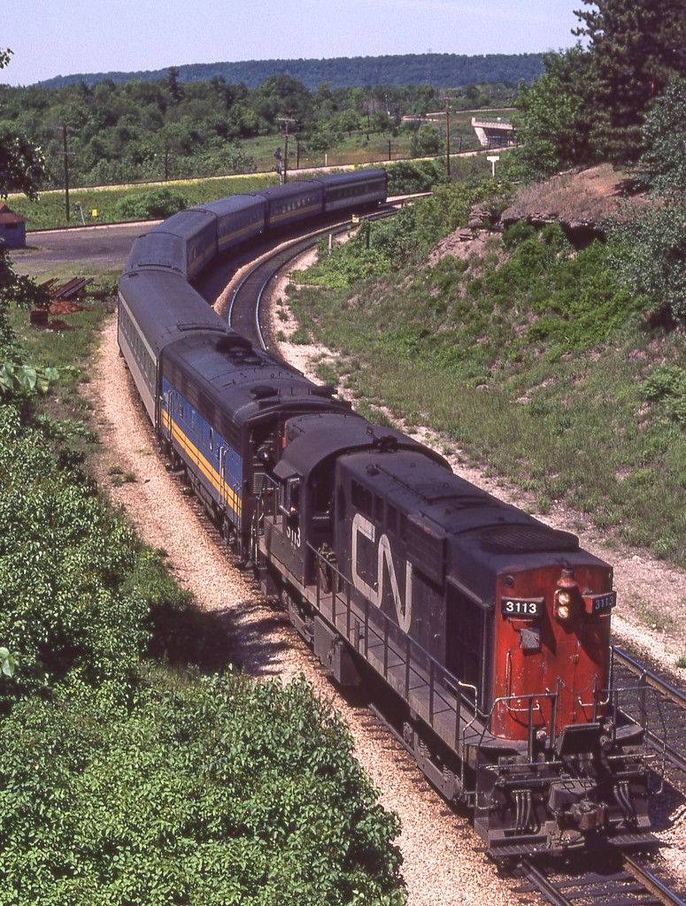 CN 3113's VIA train is eastbound leaving Hamilton West in Hamilton, Ontario on June 17, 1980.