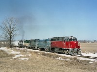Its early spring and a nice day as a southbound GEXR salt train powers up as it leaves Goderich for Stratford. Although this image is but 20 years old, times have certainly changed on the railroad. For one thing, all the power has long departed. Seen are GEXR 4019, 4161, 3834, 177 and Georgia Southwestern 2127. The scene is on approach to popular Black's Point Rd, a shortcut to a nice swimming beach from Hwy 8 to the lake. At least it used to be. High water has killed many beaches along Lake Huron this year.
Disposal of power...4019 to OVR 2009, 4161 (slug)scrapped 2008, 3834 (slug-mother)scrapped 2013, 177 scrapped 2008 and the GSWR 2127, which in this image looks like it is carrying the load, scrapped 2008.