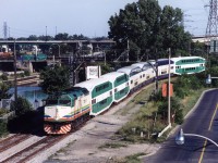 In 2001 GO Transit borrowed (leased) equipment from Miami area's Florida Tri-Rail and Vancouver's West Coast Express.<br> 
A train of this leased equipment was photographed the week after "9-11" heading north along the west bank of the lower Don River. Vantage point was Eastern Avenue bridge. It had departed Union Station eastward a few minutes earlier and would make station stops terminating at Richmond Hill. <br><br>
Florida Tri-Rail was equipped with bi-level coaches in the same colour scheme as GO Transit except for Tri-Rail emblems. Potentially this made it easier to sell the coaches (to GO) if the South Florida commuter train service was not viable. However Tri-Rail's 480 Volt HEP (matching Amtrak, VIA, etc) is incompatible with GO's 575 Volt system.   