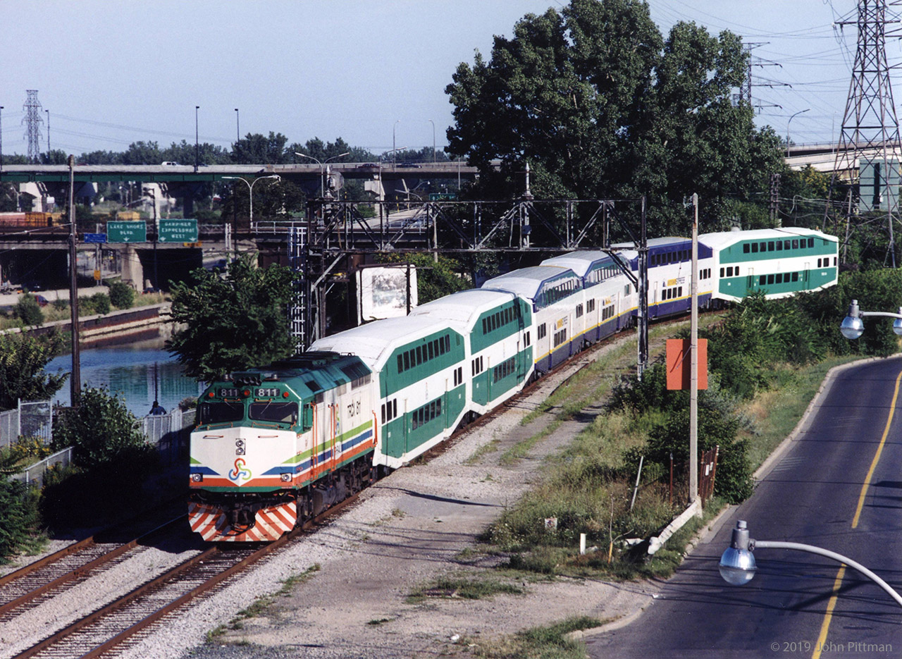 In 2001 GO Transit borrowed (leased) equipment from Miami area's Florida Tri-Rail and Vancouver's West Coast Express. 
A train of this leased equipment was photographed the week after "9-11" heading north along the west bank of the lower Don River. Vantage point was Eastern Avenue bridge. It had departed Union Station eastward a few minutes earlier and would make station stops terminating at Richmond Hill. 
Florida Tri-Rail was equipped with bi-level coaches in the same colour scheme as GO Transit except for Tri-Rail emblems. Potentially this made it easier to sell the coaches (to GO) if the South Florida commuter train service was not viable. However Tri-Rail's 480 Volt HEP (matching Amtrak, VIA, etc) is incompatible with GO's 575 Volt system.