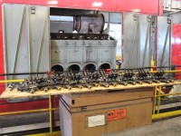 25% of an SD60's valve springs and associated hardware neatly lined up for inspection.