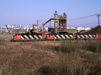 Another shot of the Brazeau Sub Local in front of the Stelco facility. This time, the scrap metal shredder can be seen, as well as downtown Edmonton (the white tall building off on its own, to the right is the CN tower).
The company operation the site now, may have a similar shredder, but I suspect that the scene is quite different now, if one could even get there. An oil loading facility now occupies the area where i was standing.