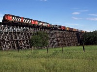 Skycover conditions improved dramatically by the time we reached this location. This is the largest wooden trestle that I have seen (likely will ever see). I had every intention of returning here, but that never happened. It would have been nice to chase a loaded sulphur train on this line. There are a number of wooden trestles on this line, including one at Sangudo, just a few miles to the east of this location. We decided to forgo that one in order to get Rochfort Bridge and with a quick escape, the next on further west.