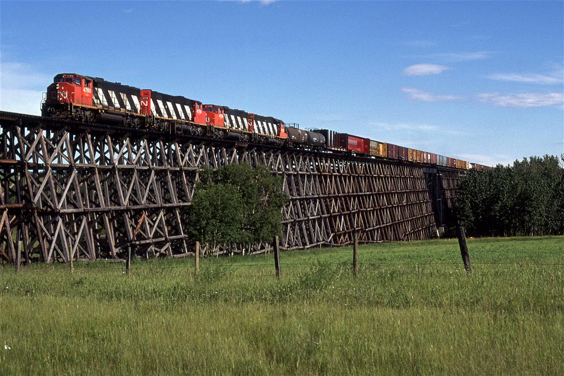 Skycover conditions improved dramatically by the time we reached this location. This is the largest wooden trestle that I have seen (likely will ever see). I had every intention of returning here, but that never happened. It would have been nice to chase a loaded sulphur train on this line. There are a number of wooden trestles on this line, including one at Sangudo, just a few miles to the east of this location. We decided to forgo that one in order to get Rochfort Bridge and with a quick escape, the next on further west.