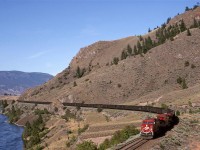 CP sent this coal train very late in the afternoon, or early evening. There was another GE as a mid train helper. I think that I saw more GE's and EMD's on this day on CP. 
There appears to be an earlier grade nearer to the river, adjacent to the pole line.