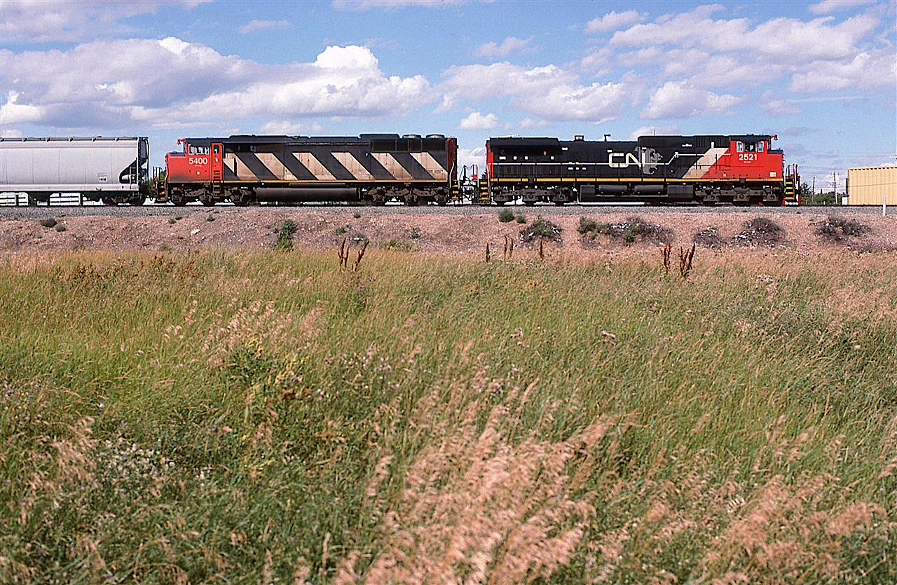 Acouple large engines are assigned to the Edmonton to Calgary train quite regularly. Leading is CN's first standard body type of GE, and trailing is CN's first Cowled type of locomotive (or did the HR616 precede this?).