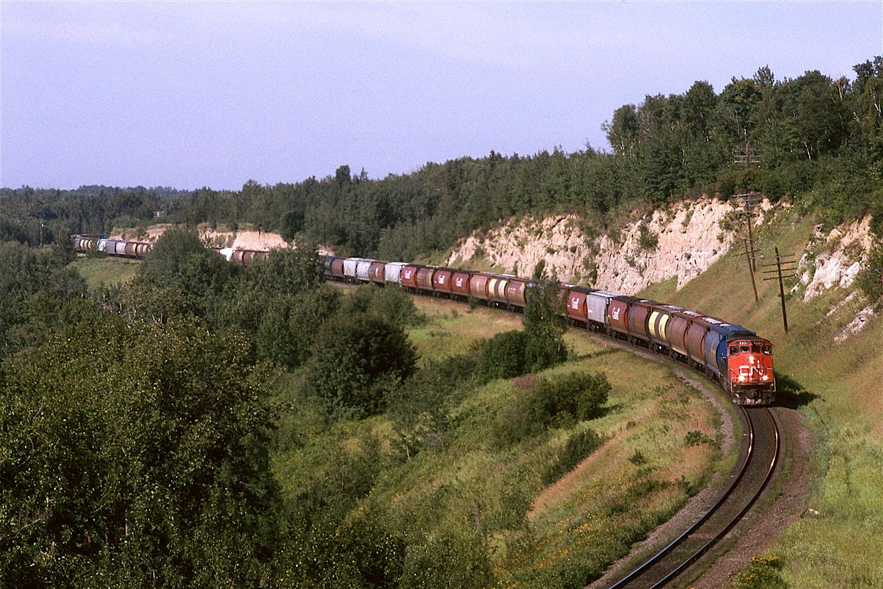 Waldron Curve out at the west end of Wabamun Lake sees yet another train pass. This is a not uncommon one unit wonder empty grain train heading to Edmonton.